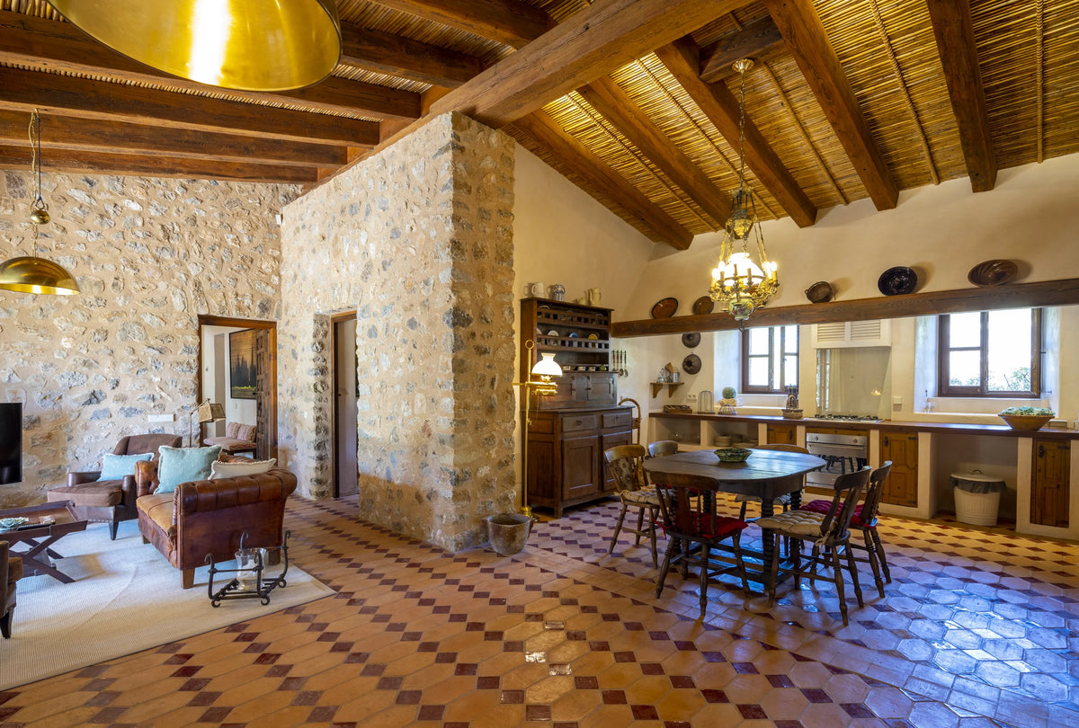 Dining area and kitchen with stone walls in The Lodge